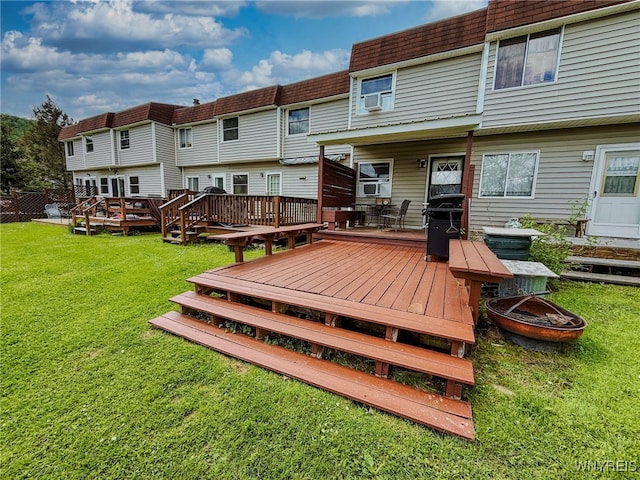 26 Pine Tree Village Rd Unit 26, Ellicottville, NY 14731 - rear view of house with mansard roof, a wooden deck, a lawn, and a fire pit