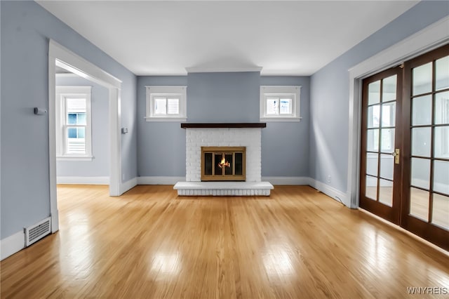 75 N Park Ave, Buffalo, NY 14216 - unfurnished living room with french doors, light wood-style flooring, and healthy amount of natural light