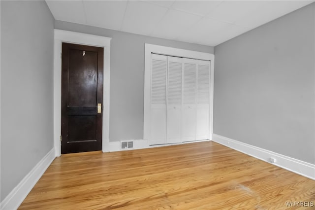 75 N Park Ave, Buffalo, NY 14216 - unfurnished bedroom with baseboards, light wood-style flooring, and a closet