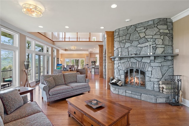 436 Steuben St, Reading, NY 14891 - living area featuring wood finished floors, crown molding, a stone fireplace, and recessed lighting