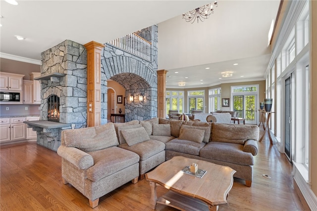 436 Steuben St, Reading, NY 14891 - living room featuring a fireplace, ornamental molding, light wood-type flooring, arched walkways, and recessed lighting