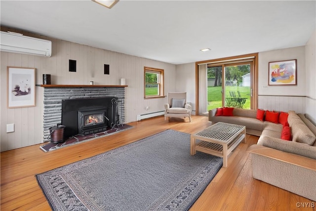 3583 W Seneca Tpke, Onondaga, NY 13215 - living room with a baseboard heating unit, an AC wall unit, wood finished floors, plenty of natural light, and wood walls