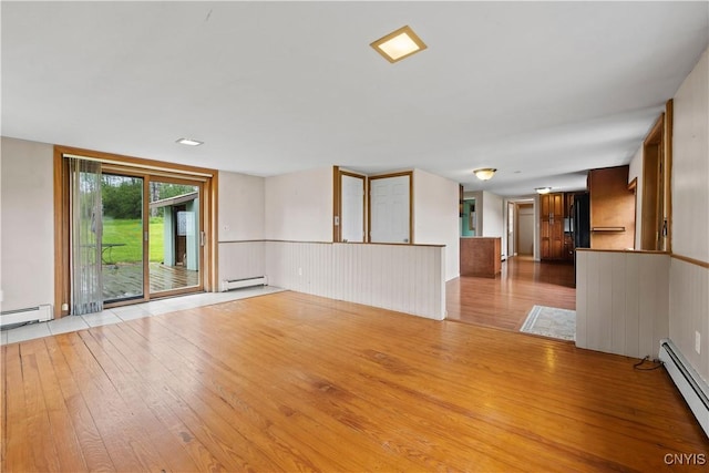 3583 W Seneca Tpke, Onondaga, NY 13215 - unfurnished living room with a baseboard heating unit, light wood-style floors, and a baseboard radiator