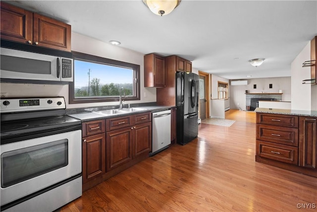 3583 W Seneca Tpke, Onondaga, NY 13215 - kitchen featuring stainless steel appliances, a sink, wood finished floors, and open floor plan