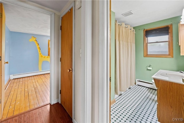 3583 W Seneca Tpke, Onondaga, NY 13215 - bathroom featuring a baseboard radiator, vanity, baseboard heating, and a shower with curtain