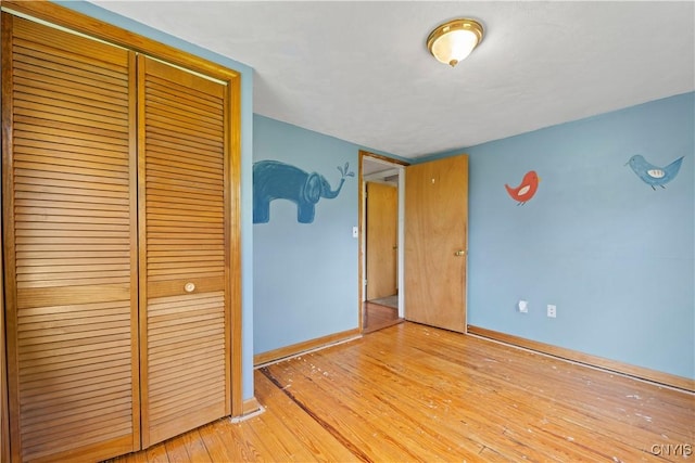 3583 W Seneca Tpke, Onondaga, NY 13215 - unfurnished bedroom with a closet, baseboards, and light wood-type flooring
