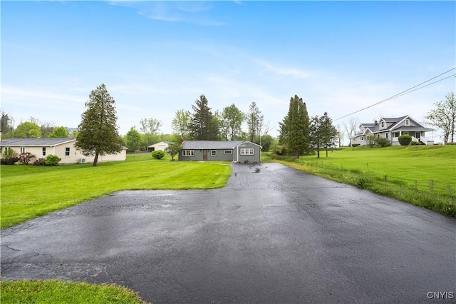 3583 W Seneca Tpke, Onondaga, NY 13215 - view of front facade featuring asphalt driveway, a front yard, and a residential view