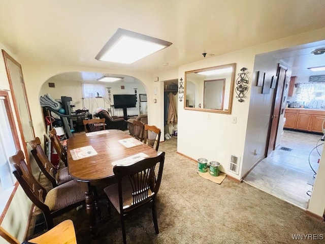28 Boyd St, Buffalo, NY 14213 - dining space with arched walkways, light colored carpet, and baseboards