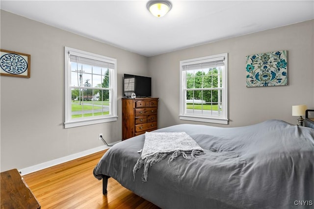915 W Thomas St, Rome-Inside, NY 13440 - bedroom featuring multiple windows, wood finished floors, and baseboards