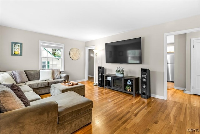 915 W Thomas St, Rome-Inside, NY 13440 - living room with light wood-style flooring, baseboards, and a fireplace