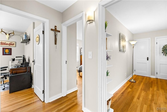 915 W Thomas St, Rome-Inside, NY 13440 - hallway featuring a desk, light wood finished floors, and baseboards