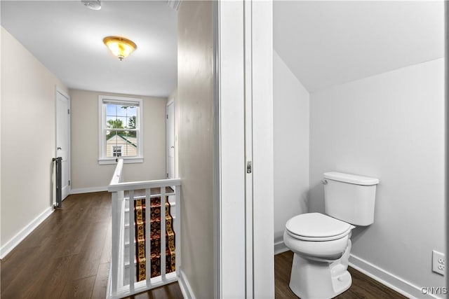 915 W Thomas St, Rome-Inside, NY 13440 - bathroom featuring toilet, wood finished floors, and baseboards