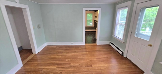 104 Main St, Stamford, NY 12167 - empty room with baseboard heating, healthy amount of natural light, wood finished floors, and baseboards