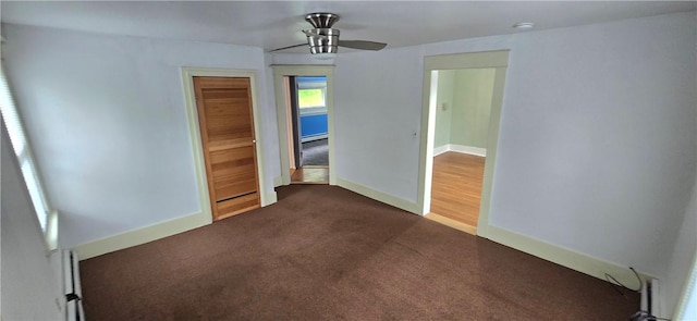 104 Main St, Stamford, NY 12167 - unfurnished room with baseboard heating, dark colored carpet, baseboards, and a ceiling fan