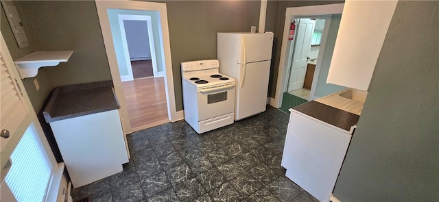 104 Main St, Stamford, NY 12167 - kitchen with white appliances, dark countertops, baseboard heating, and baseboards