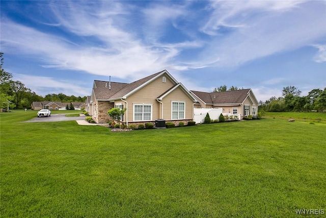 5692 Ferncrest Ct Unit B, Clarence, NY 14032 - ranch-style house with a front yard, central air condition unit, and roof with shingles