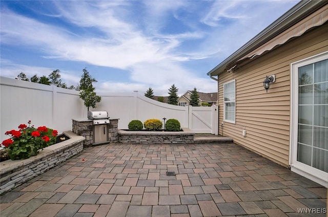 5692 Ferncrest Ct Unit B, Clarence, NY 14032 - fenced backyard with a patio and a gate