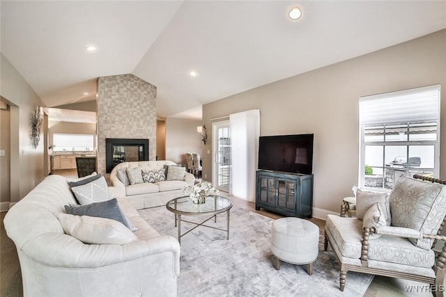 5692 Ferncrest Ct Unit B, Clarence, NY 14032 - living room featuring lofted ceiling, baseboards, a fireplace, recessed lighting, and wood finished floors