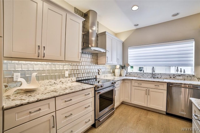5692 Ferncrest Ct Unit B, Clarence, NY 14032 - kitchen with stainless steel appliances, a sink, wall chimney exhaust hood, plenty of natural light, and recessed lighting