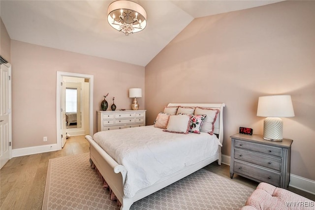 5692 Ferncrest Ct Unit B, Clarence, NY 14032 - bedroom featuring vaulted ceiling, wood finished floors, a chandelier, and baseboards
