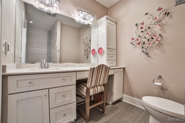 5692 Ferncrest Ct Unit B, Clarence, NY 14032 - bathroom with toilet, baseboards, and vanity