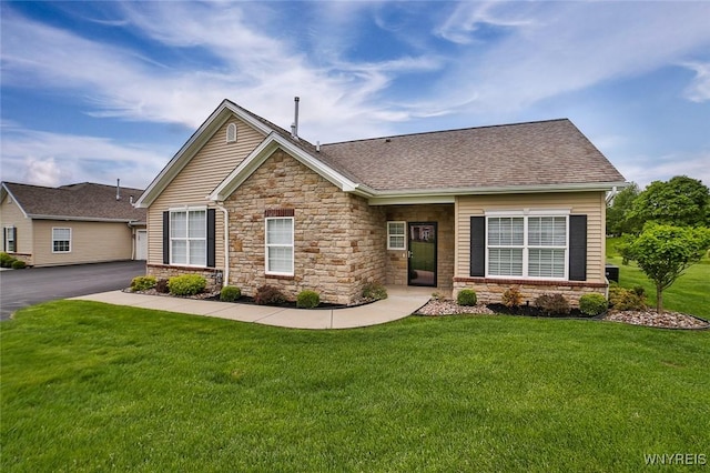 5692 Ferncrest Ct Unit B, Clarence, NY 14032 - view of front of property with stone siding, a front yard, and roof with shingles