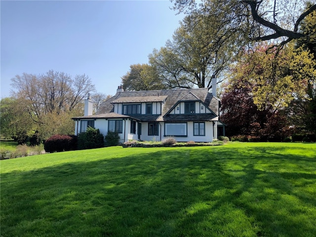 700 Rock Beach Rd, Irondequoit, NY 14617 - view of front of house with a chimney and a front lawn