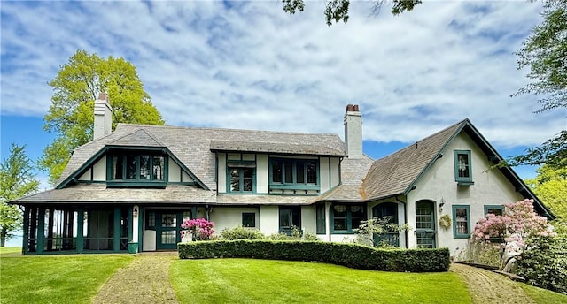 700 Rock Beach Rd, Irondequoit, NY 14617 - back of house featuring a chimney, stucco siding, and a yard