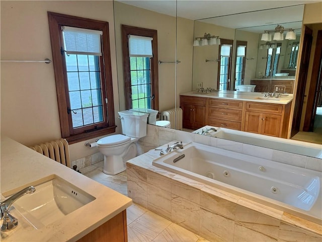 700 Rock Beach Rd, Irondequoit, NY 14617 - full bathroom featuring radiator, toilet, double vanity, and a whirlpool tub