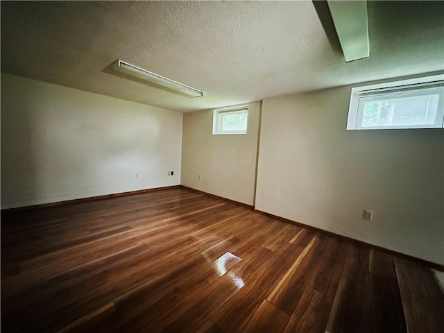 218 Grant St, Elmira-City, NY 14901 - basement with wood finished floors, a textured ceiling, and baseboards
