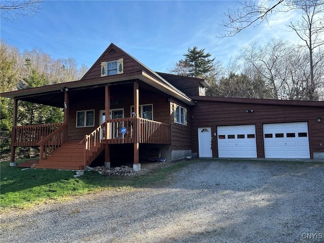 103 Onondaga Rd, Webb, NY 13420 - view of front of home featuring driveway, stairway, a garage, and covered porch