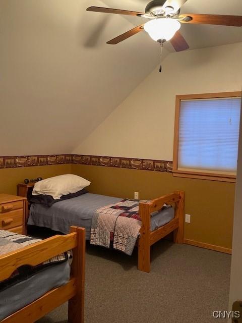103 Onondaga Rd, Webb, NY 13420 - bedroom with vaulted ceiling, a ceiling fan, and carpet flooring
