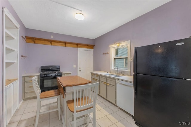 10 Garfield St Unit 10, Cortland, NY 13045 - kitchen with black appliances, a sink, light countertops, and light tile patterned floors