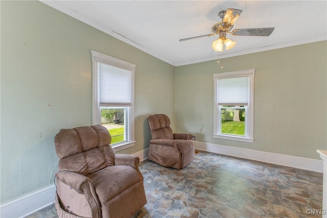 10 Garfield St Unit 10, Cortland, NY 13045 - living area with stone flooring, healthy amount of natural light, a ceiling fan, baseboards, and ornamental molding