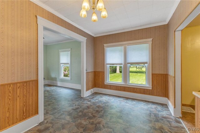 10 Garfield St Unit 10, Cortland, NY 13045 - spare room featuring stone floors, ornamental molding, a chandelier, wainscoting, and wallpapered walls