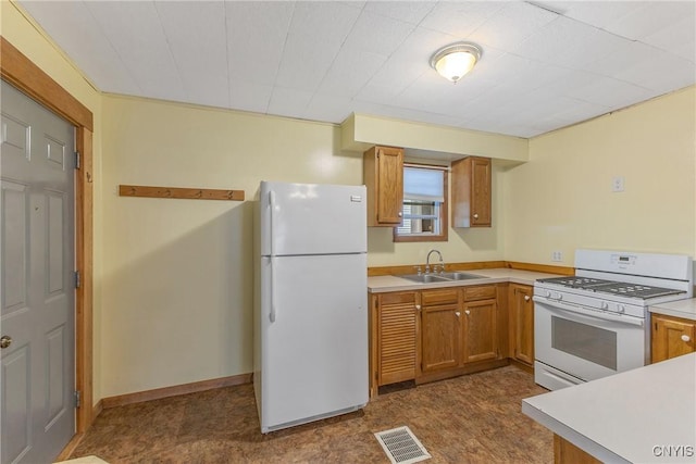 10 Garfield St Unit 10, Cortland, NY 13045 - kitchen featuring white appliances, a sink, light countertops, and brown cabinetry