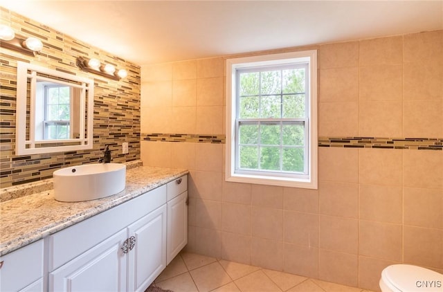 8929 State Route 12e, Lyme, NY 13622 - bathroom with vanity, tile patterned floors, healthy amount of natural light, tile walls, and decorative backsplash