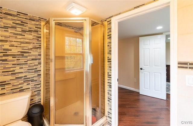 8929 State Route 12e, Lyme, NY 13622 - full bath featuring tile walls, a stall shower, wood finished floors, toilet, and recessed lighting