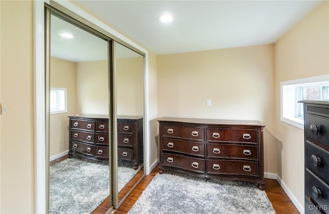 8929 State Route 12e, Lyme, NY 13622 - bedroom featuring dark wood-style floors, a closet, and multiple windows