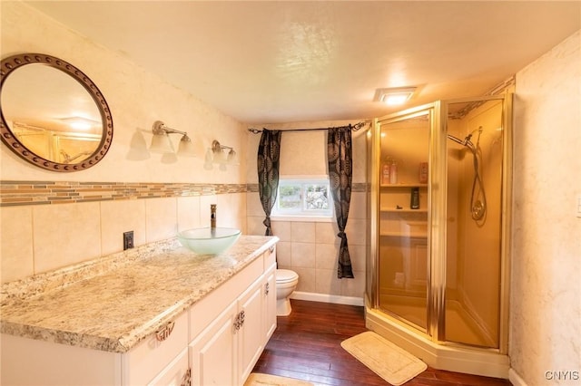 8929 State Route 12e, Lyme, NY 13622 - bathroom with tile walls, a shower stall, vanity, and wood-type flooring