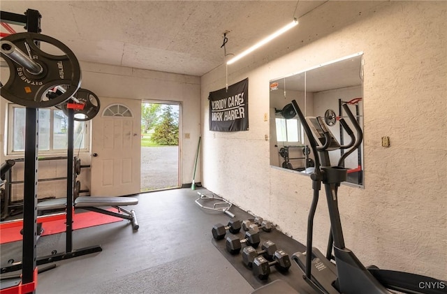 8929 State Route 12e, Lyme, NY 13622 - exercise room featuring healthy amount of natural light and a textured wall