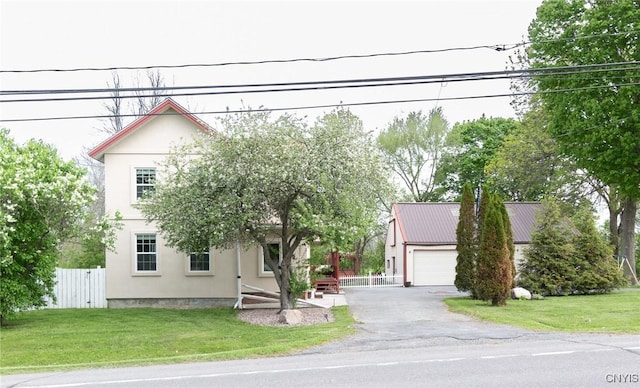 8929 State Route 12e, Lyme, NY 13622 - view of property hidden behind natural elements with stucco siding, a garage, and driveway