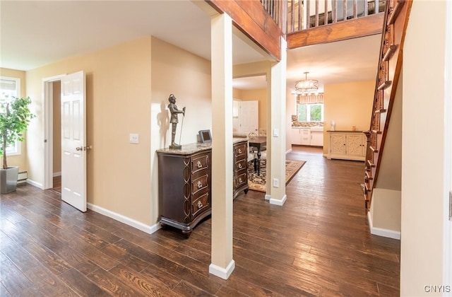 8929 State Route 12e, Lyme, NY 13622 - corridor with dark wood-type flooring, baseboards, stairs, and a baseboard heating unit
