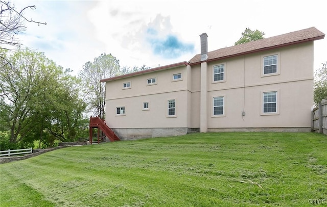 8929 State Route 12e, Lyme, NY 13622 - back of house with a chimney, stucco siding, and stairway