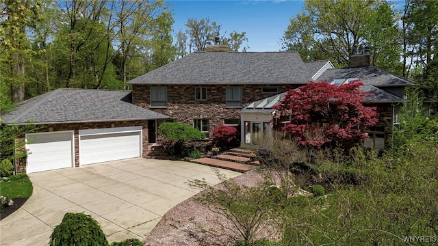 52 Hidden Pines Ct, Amherst, NY 14051 - view of front of house with a chimney, driveway, a garage, and stone siding