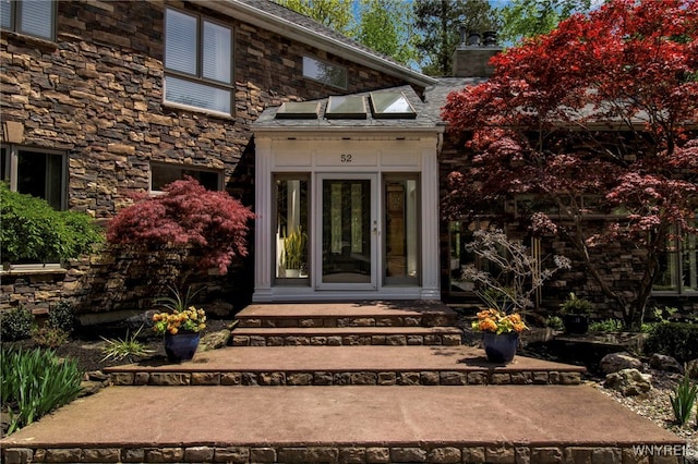 52 Hidden Pines Ct, Amherst, NY 14051 - entrance to property featuring a chimney and stone siding