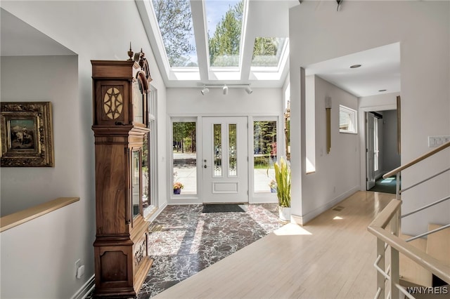 52 Hidden Pines Ct, Amherst, NY 14051 - foyer with wood finished floors, baseboards, a skylight, and stairway