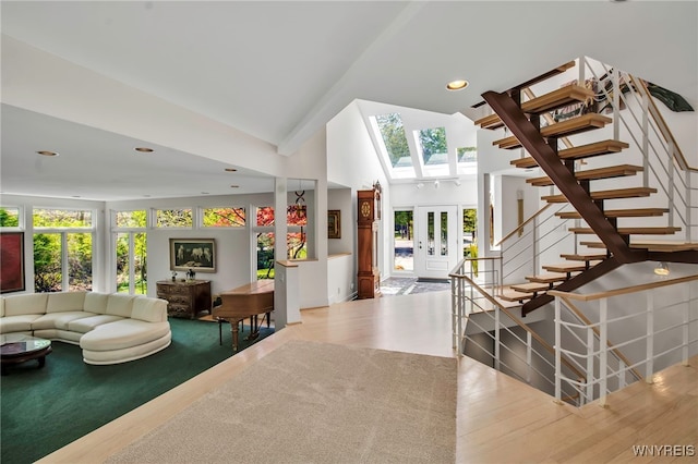 52 Hidden Pines Ct, Amherst, NY 14051 - living area featuring wood finished floors, stairs, a skylight, and a towering ceiling