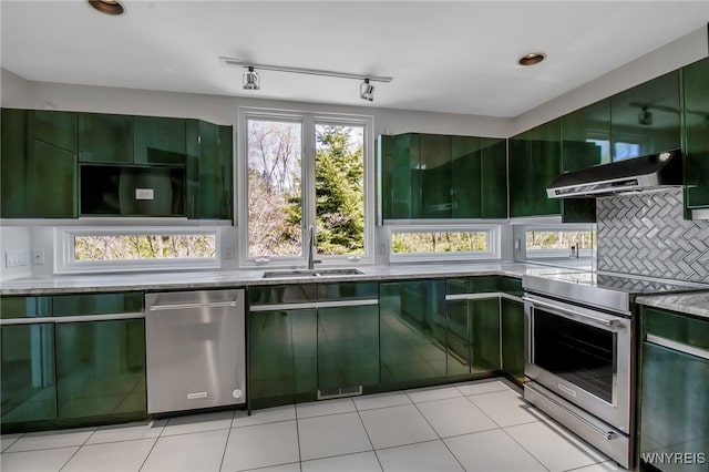 52 Hidden Pines Ct, Amherst, NY 14051 - kitchen featuring appliances with stainless steel finishes, green cabinetry, under cabinet range hood, a sink, and plenty of natural light