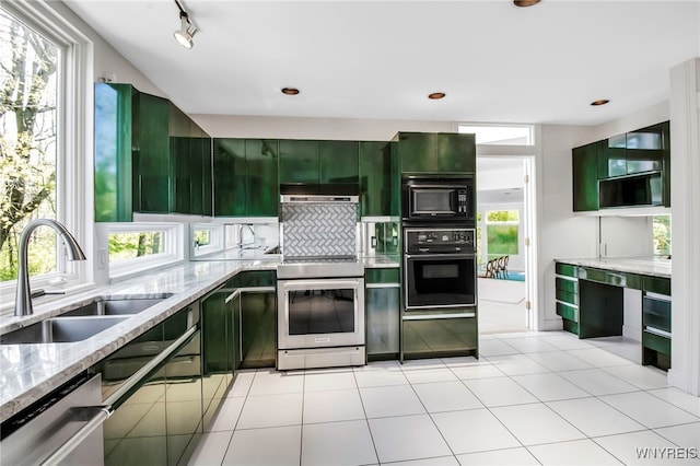 52 Hidden Pines Ct, Amherst, NY 14051 - kitchen with black appliances, a sink, green cabinetry, light stone countertops, and decorative backsplash